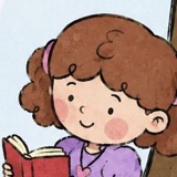 Sophie, with curly brown hair and pink bobbles, reading a book.